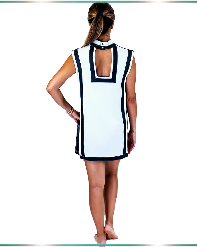 model showing the back of the white and black dress with the rectangular opening and black stripe around the shape
