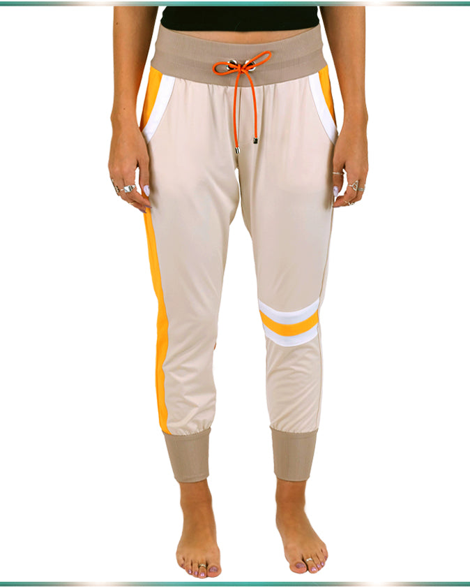 Zoom in on the front of the pants showing the orange cord at the wide waistband and asymmetrical design with orange stripes