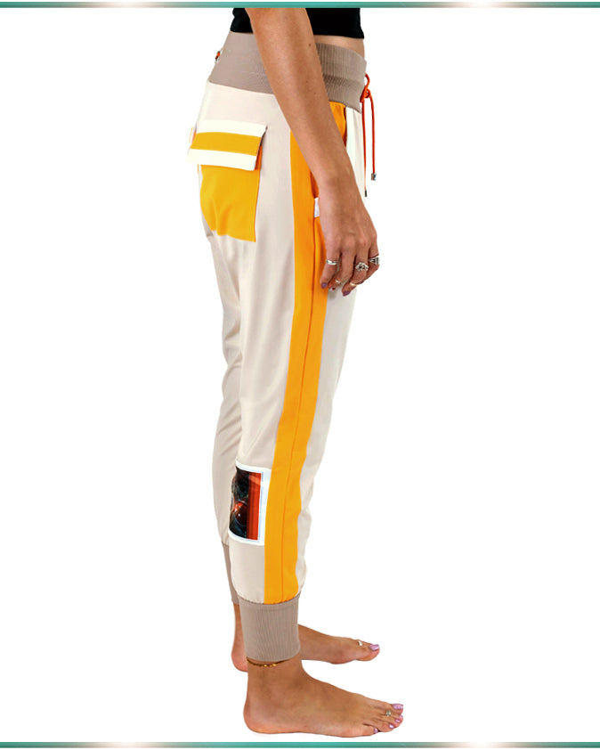 side view of the pants showing the orange stripe of the tan color lounging pants