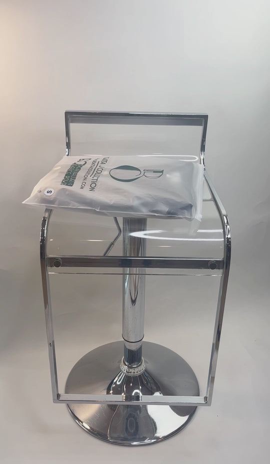 a video showing a Beatta J Collection garment (Panthera Silver dress) in the special plastic, recycle bag that is freezable. The garment is shown to be taken out of the bag and few sprays of the PYE mist applied towards the garment.