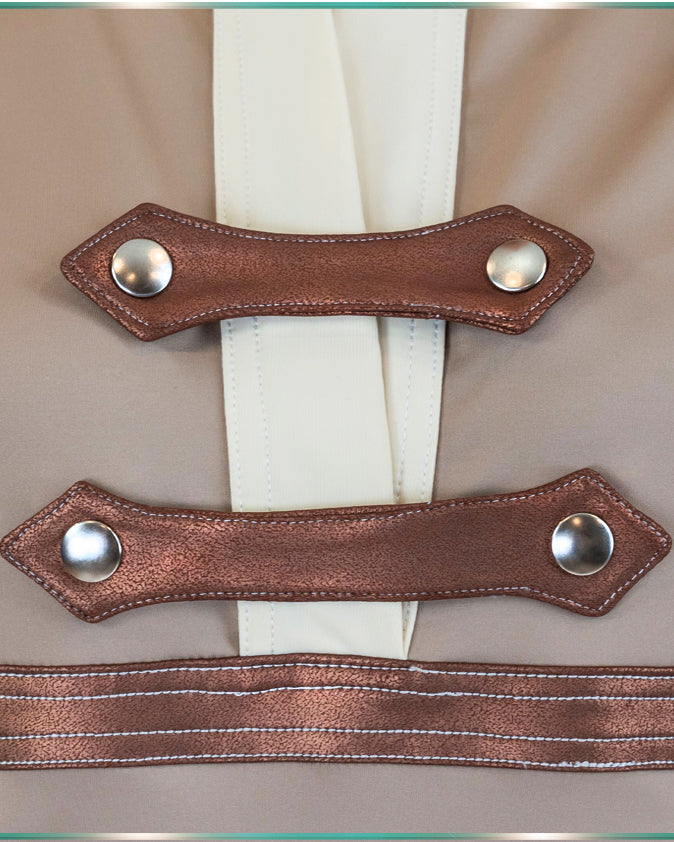 Close up on the upper front closure of the blouse showing off the copper deail snaps with the silver buttons and white stiching.