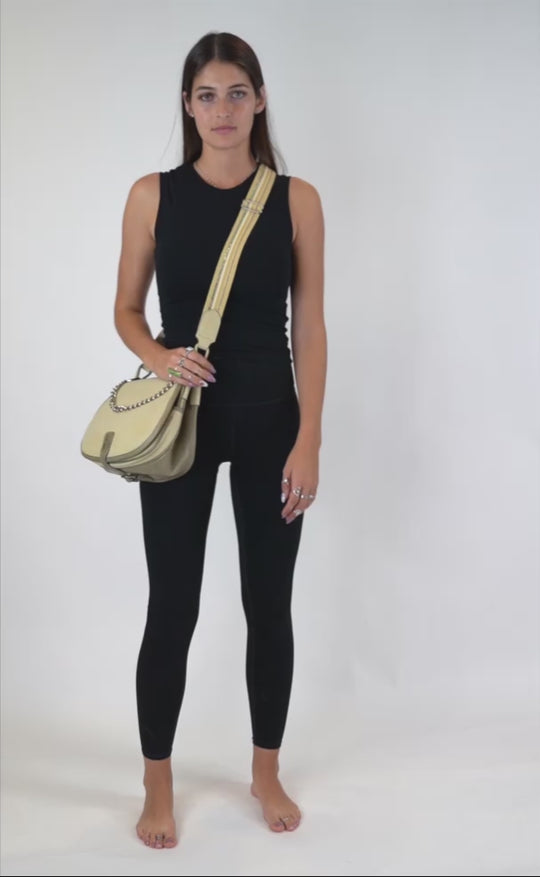 A video of the model wearing our handbag in cream/sage color combination  showing it off in 360 degree.